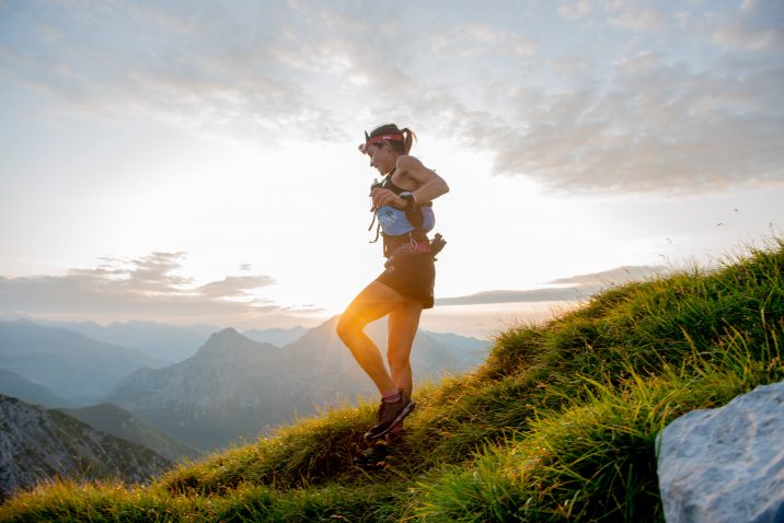 A female ultra runner running through the mountains