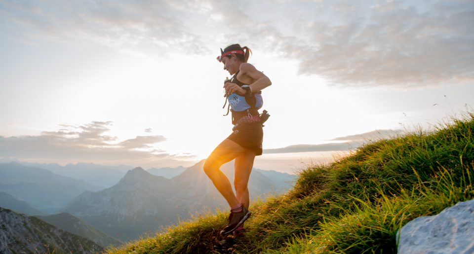 A female ultra runner running through the mountains